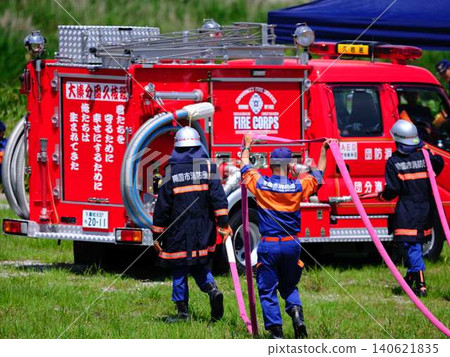 Firefighters conducting fire drills at the New Year's fire brigade parade. Firefighters conducting fire drills at the New Year's fire brigade parade. 140621835