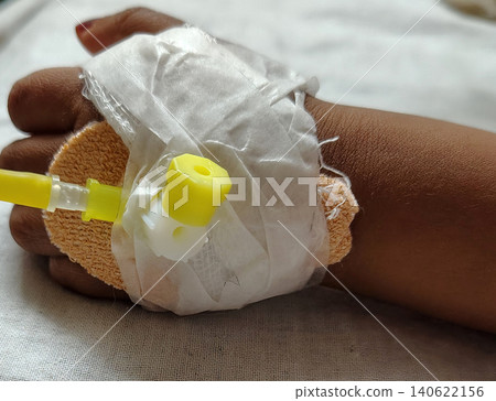 Hospital intravenous catheter on hand of small patient for medical treatment. 140622156