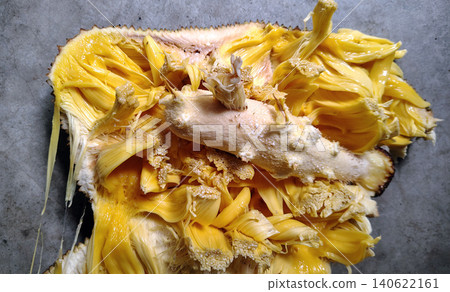 Central core of jackfruit surrounded by sweet yellow fruit segments. 140622161