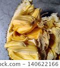 Fresh open jackfruit revealing yellow pods and fibrous texture on stone background. Fresh open jackfruit revealing yellow pods and fibrous texture on stone background. 140622166