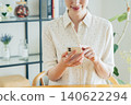Young woman using a smartphone at home 140622294
