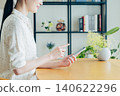 Young woman using a smartphone at home 140622296