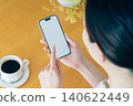 Young woman using a smartphone at home 140622449