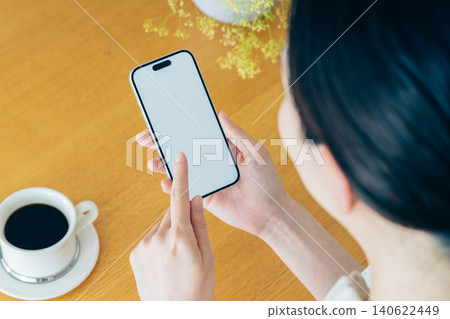 Young woman using a smartphone at home 140622449