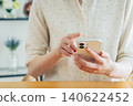 Young woman using a smartphone at home 140622452