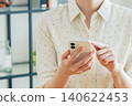 Young woman using a smartphone at home 140622453