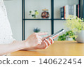 Young woman using a smartphone at home 140622454