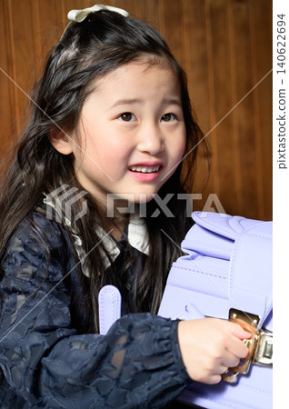 A Japanese girl opening her schoolbag A Japanese girl opening her schoolbag 140622694