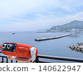 Viewing the early summer sea through a coin-operated telescope. 140622947