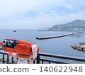 Viewing the early summer sea through a coin-operated telescope. 140622948