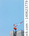 A construction crane operating under a blue sky (vertical orientation, copy space available) 140623779