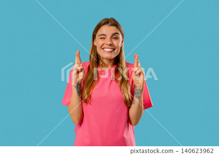 Believer Woman Praying, Crossed Fingers, Blue Background. Hope, Wish, Gratitude 140623962