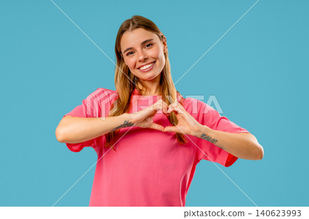 Smiling Charming Woman Showing Sign Of Shape Heart. Romantic Woman On Blue Smiling Charming Woman Showing Sign Of Shape Heart. Romantic Woman On Blue 140623993