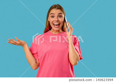 Amazed blonde woman talking by phone, nice joke, smiling. Young lady on Blue Amazed blonde woman talking by phone, nice joke, smiling. Young lady on Blue 140623994