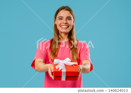 Happy Blonde Woman Gift Box On Blue Background. Young Girl Smiling, Gives You Happy Blonde Woman Gift Box On Blue Background. Young Girl Smiling, Gives You 140624013