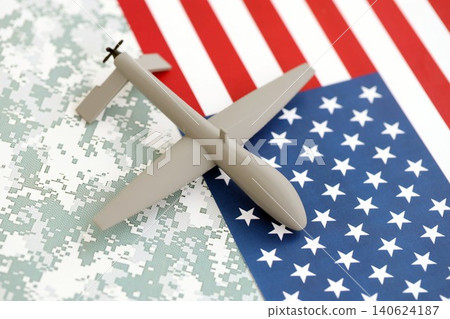 Drone unmanned autonomous technology of espionage and strikes on the enemy. Toy uav drone on flag Drone unmanned autonomous technology of espionage and strikes on the enemy. Toy uav drone on flag 140624187