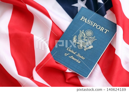 United States passport book on US flag close up. Travel document on official banner United States passport book on US flag close up. Travel document on official banner 140624189