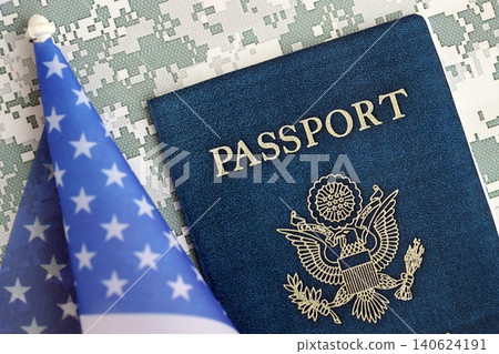 United States passport book with US flag on camouflage uniform close up United States passport book with US flag on camouflage uniform close up 140624191