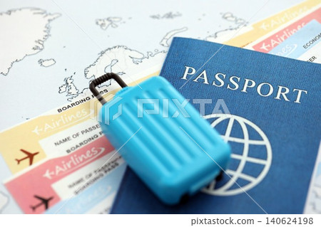 Passport with boarding pass tickets and toy luggage bag on world map Passport with boarding pass tickets and toy luggage bag on world map 140624198