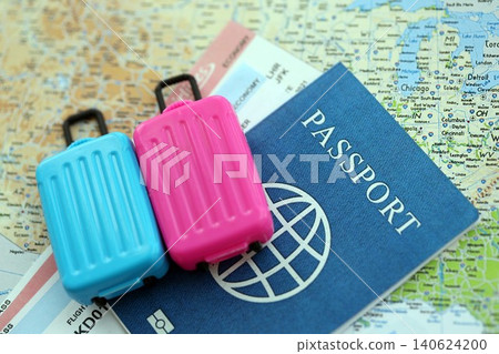 Passport with boarding pass tickets and toy luggage bag on United States map Passport with boarding pass tickets and toy luggage bag on United States map 140624200
