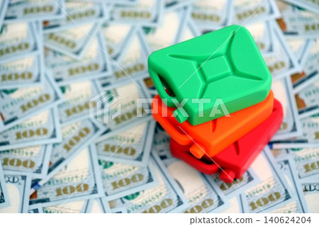 Petroleum or gasoline canister reservoir lies on big amount of dollar bills Petroleum or gasoline canister reservoir lies on big amount of dollar bills 140624204