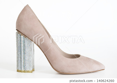 Elegant beige suede pump with silver block heel on clean white background fashion image Elegant beige suede pump with silver block heel on clean white background fashion image 140624260
