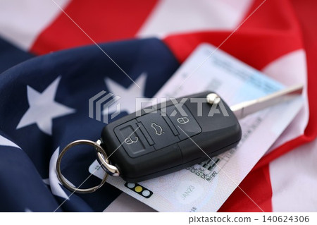Ignition keys with remote control buttons and driver license card on United States flag Ignition keys with remote control buttons and driver license card on United States flag 140624306