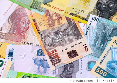 Congolese franc money bills in big amount on table close up. Rich life concept in Congo Congolese franc money bills in big amount on table close up. Rich life concept in Congo 140624317