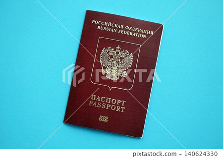 Russian Federation red passport on light blue table background. Concept of travel and tourism Russian Federation red passport on light blue table background. Concept of travel and tourism 140624330