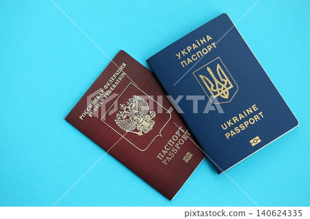 Ukraine and Russian Federation passports on light blue table background. Restrictions and sanctions Ukraine and Russian Federation passports on light blue table background. Restrictions and sanctions 140624335