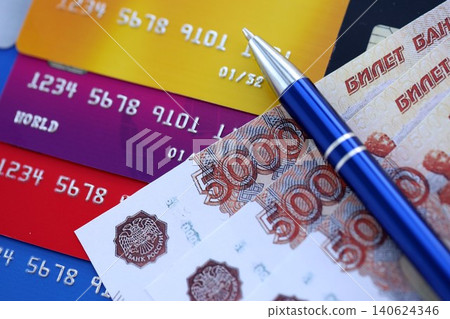 Credit cards and pen with Russian ruble currency money bills banknotes. Business, financial operations Credit cards and pen with Russian ruble currency money bills banknotes. Business, financial operations 140624346