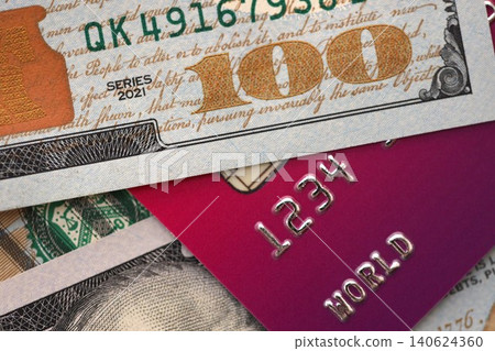 One hundred US dollar bill banknote on purple credit card for banking and payments One hundred US dollar bill banknote on purple credit card for banking and payments 140624360