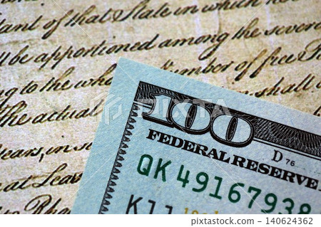 One hundred US dollar bills and United States Constitution fragment. Concept of lawsuit and bribery One hundred US dollar bills and United States Constitution fragment. Concept of lawsuit and bribery 140624362