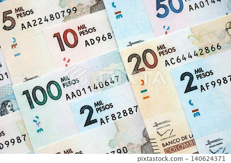 Colombian pesos money bills banknotes lies in big pile on table close up. Finances and business Colombian pesos money bills banknotes lies in big pile on table close up. Finances and business 140624371