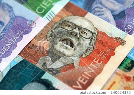 Colombian pesos money bills banknotes lies in big pile on table close up. Finances and business 140624373
