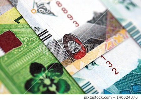 Qatari riyal money bills banknotes lies in big pile on table. Finances and business in Qatar 140624376