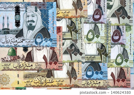 Saudi Arabia riyal money bills banknotes lies in big pile on table. Business in Saudi Arabia Saudi Arabia riyal money bills banknotes lies in big pile on table. Business in Saudi Arabia 140624380