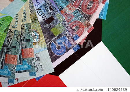 Kuwaiti dinar currency money bills lies on flag. The concept of business and investment Kuwaiti dinar currency money bills lies on flag. The concept of business and investment 140624389