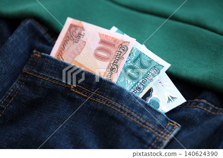 Egyptian pound money bills in denims pocket. The concept of fashion and wealth Egyptian pound money bills in denims pocket. The concept of fashion and wealth 140624390