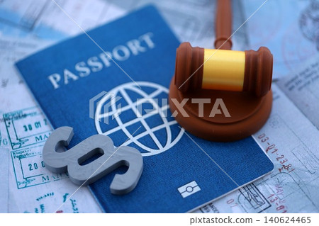 Paragraph symbol and judge hammer on passport pages full of colorful stamps after travel Paragraph symbol and judge hammer on passport pages full of colorful stamps after travel 140624465