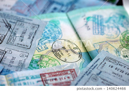 Big amount of passport pages full of colorful stamps after travel and border crossing Big amount of passport pages full of colorful stamps after travel and border crossing 140624466