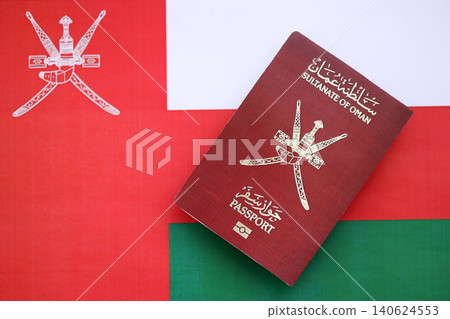 Omani passport on flag close up. Official identification document book for citizens of Oman 140624553