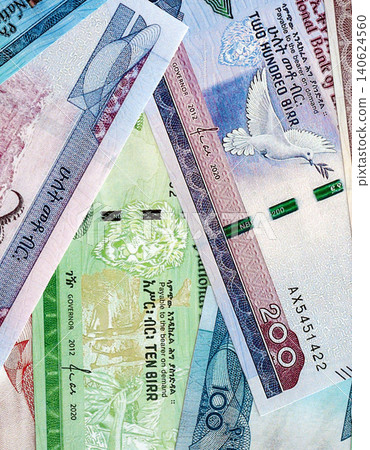 Ethiopian birr paper banknotes pile on table. Ethiopia ETB currency money bills in big amount Ethiopian birr paper banknotes pile on table. Ethiopia ETB currency money bills in big amount 140624560