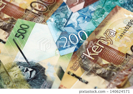 Kenyan shilling paper banknotes pile on table. Kenya KES currency money bills in big amount Kenyan shilling paper banknotes pile on table. Kenya KES currency money bills in big amount 140624571