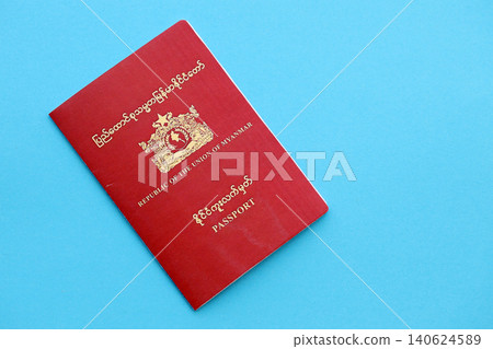 Myanmar passport on table close up. Official identification document book for citizens of Myanmar Myanmar passport on table close up. Official identification document book for citizens of Myanmar 140624589