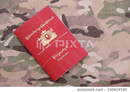 Myanmar passport on table close up. Official identification document book for citizens of Myanmar Myanmar passport on table close up. Official identification document book for citizens of Myanmar 140624590
