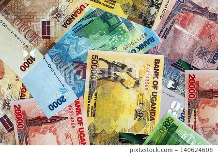 Ugandan shilling paper banknotes pile on table. Uganda UGX currency money bills in big amount Ugandan shilling paper banknotes pile on table. Uganda UGX currency money bills in big amount 140624608