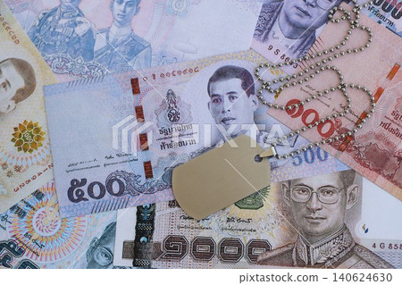 Thai baht currency money bills and military token. The concept of army service Thai baht currency money bills and military token. The concept of army service 140624630