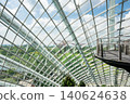 A panoramic view from inside the Cloud Forest at Gardens by the Bay, Singapore. The geometric glass panels frame the lush greenery and iconic Super tree Grove in the distance 140624638