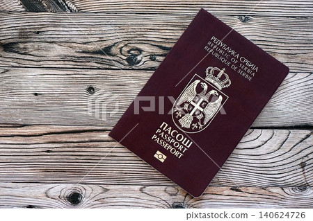Serbian passport on table close up. Official identification document book for citizens of Serbia Serbian passport on table close up. Official identification document book for citizens of Serbia 140624726